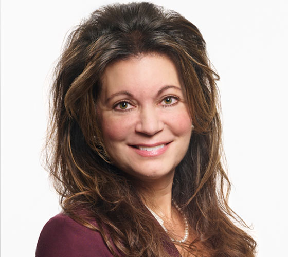 Photo of woman with brown hair smiling. 