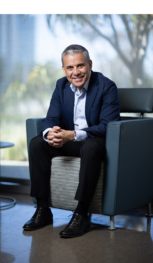 male sitting in chair, smiling
