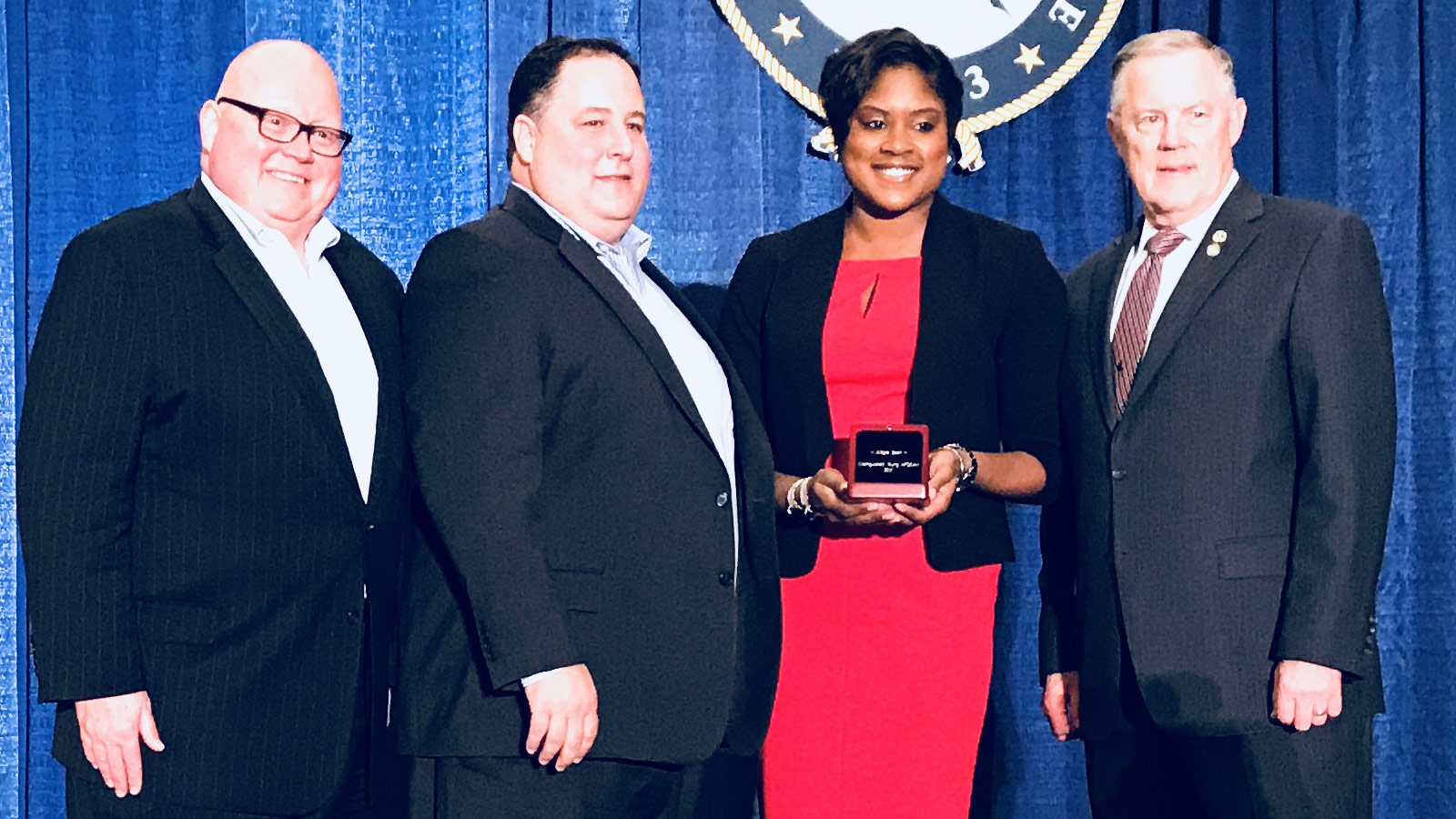 Allegra Scott Receives an AFCEA Award for Service and Achievement black woman with award standing with three men
