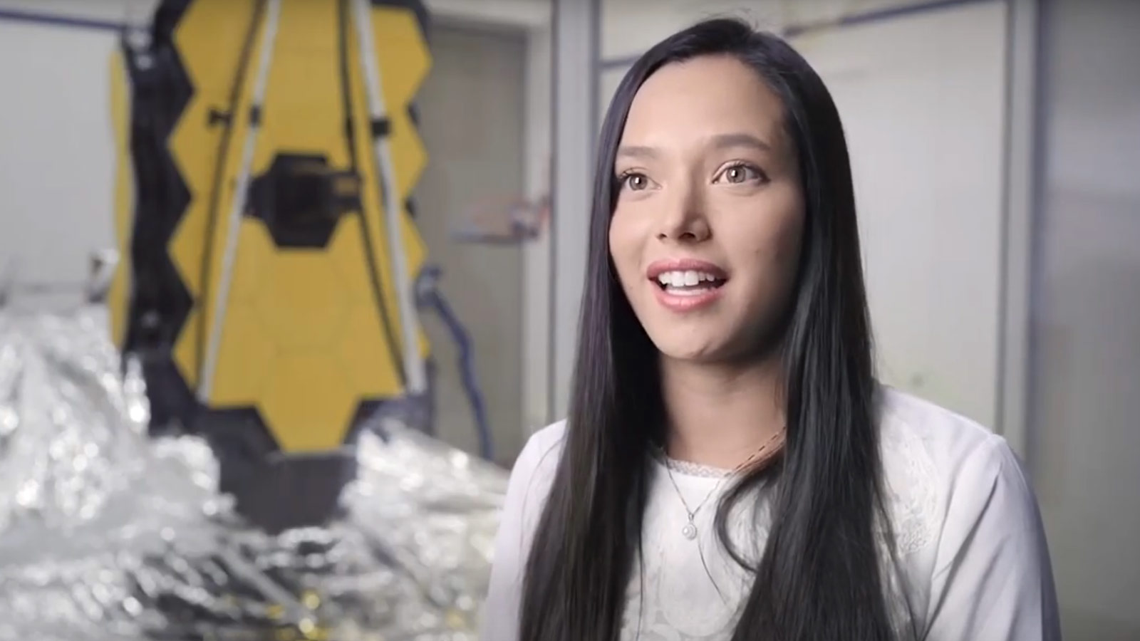From Intern to Mechanical Design Engineer on the James Webb Space Telescope white female smiling in front of space telescope