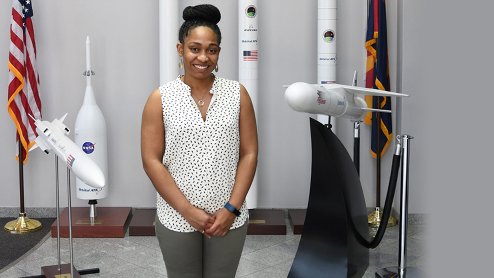 black woman in front of rocket models