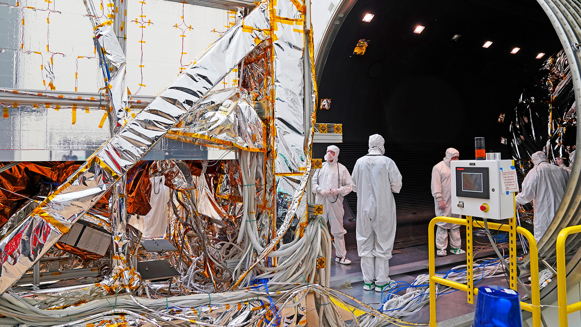 JPSS-2 completes TVAC Testing technicians dressed in bynnysuits building a satellite in cleanroom
